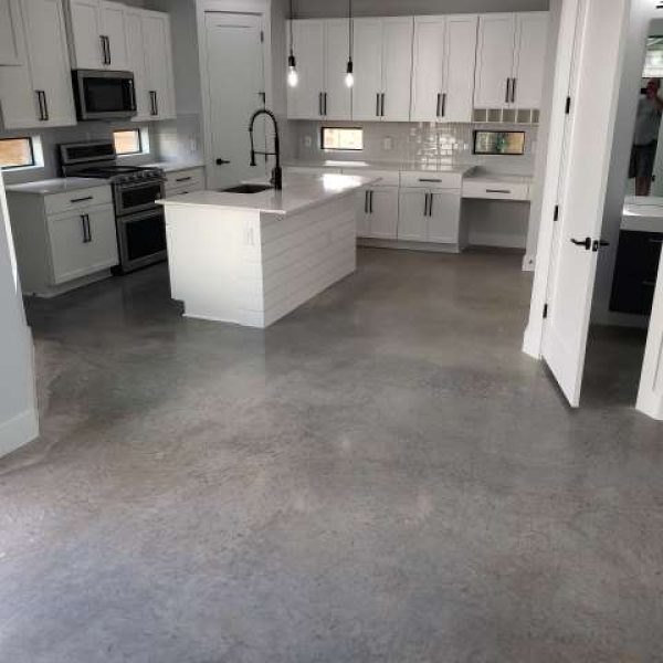 A stained concrete overlay in a kitchen, creating a unique and modern design that enhances the home's overall aesthetic.