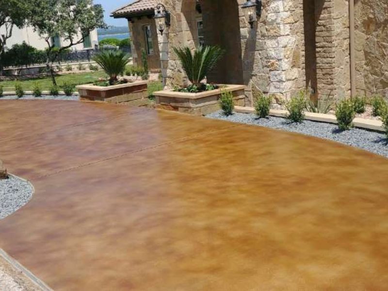 A stained concrete patio has been transformed into a beautiful outdoor living space, perfect for entertaining and relaxing.