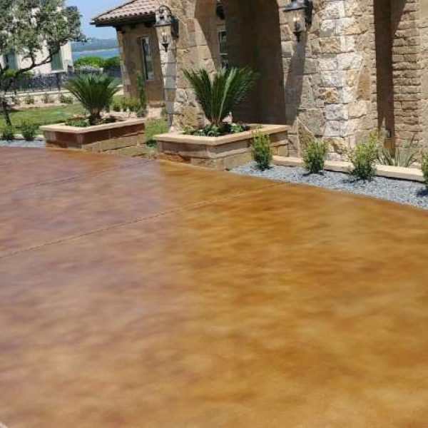 A stained concrete patio has been transformed into a beautiful outdoor living space, perfect for entertaining and relaxing.