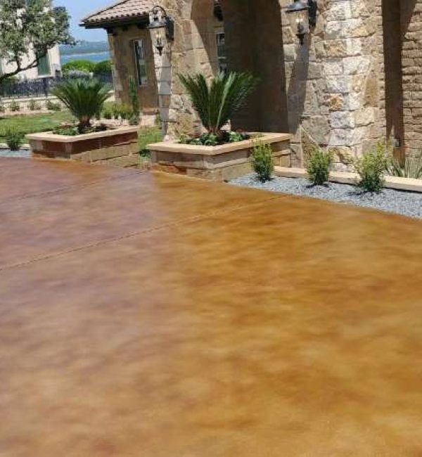 A stained concrete patio has been transformed into a beautiful outdoor living space, perfect for entertaining and relaxing.