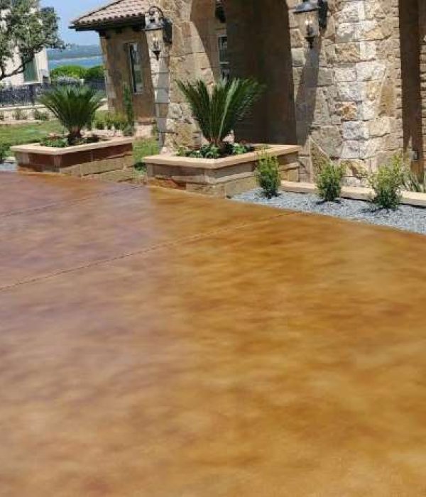 A stained concrete patio has been transformed into a beautiful outdoor living space, perfect for entertaining and relaxing.