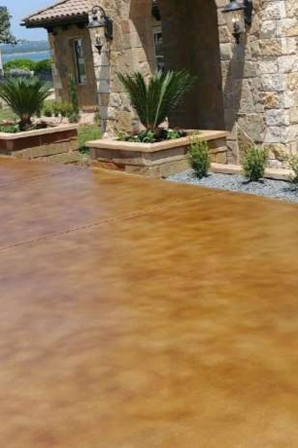 A stained concrete patio has been transformed into a beautiful outdoor living space, perfect for entertaining and relaxing.